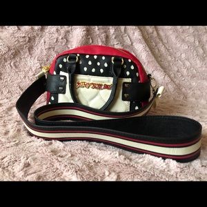Very cute red and block polka dots purse.